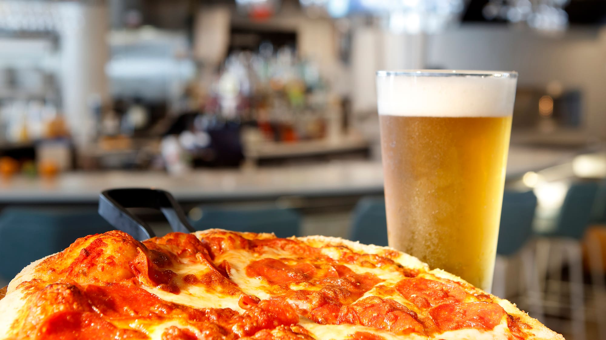 a pizza and a glass of beer