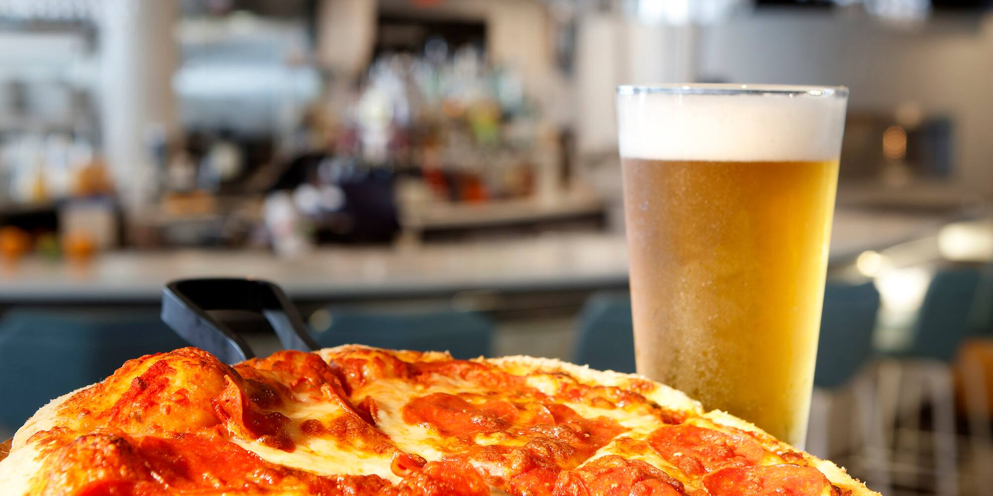 a pizza and a glass of beer