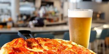 a pizza and a glass of beer