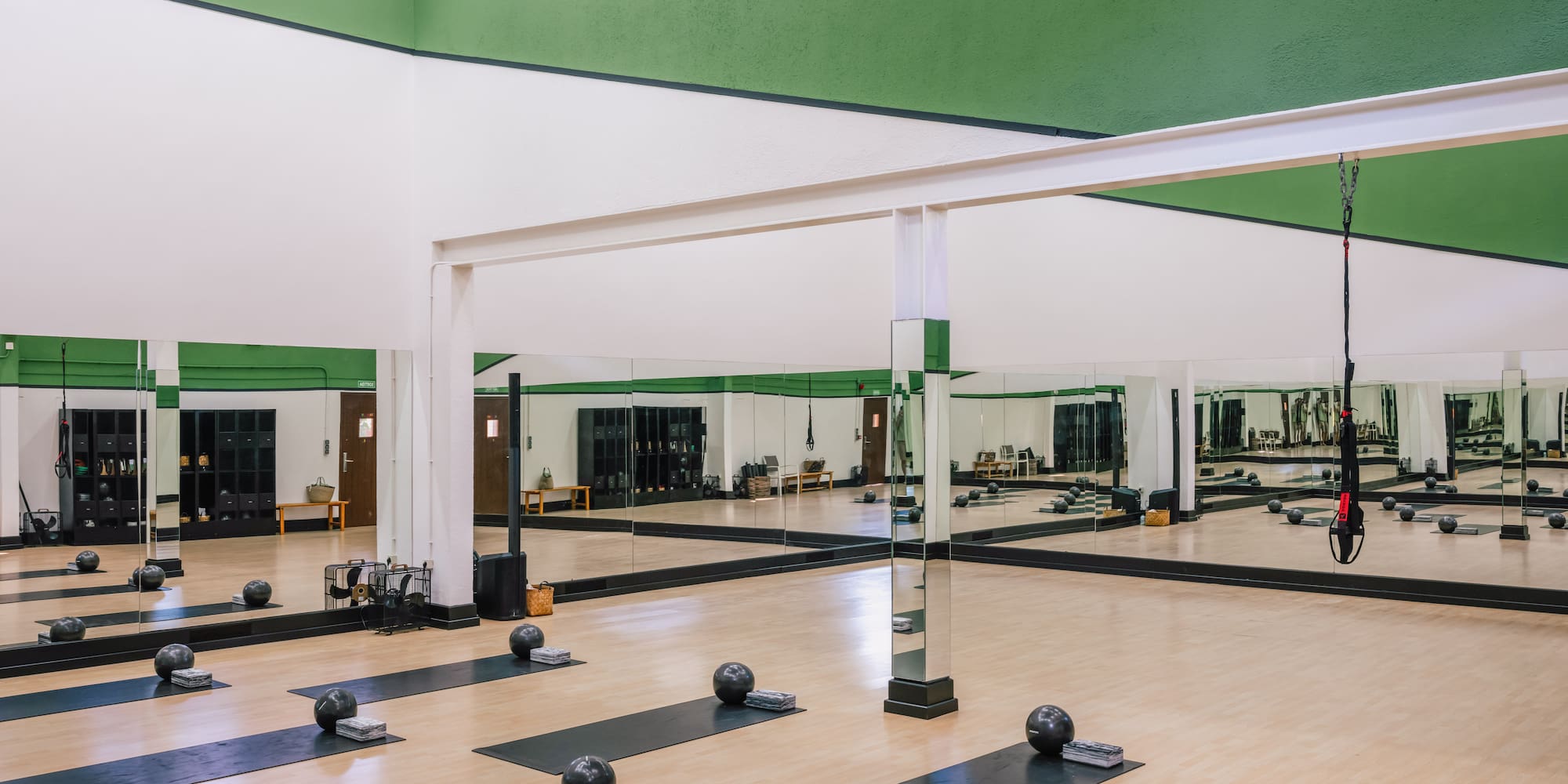 a large room with mats and balls