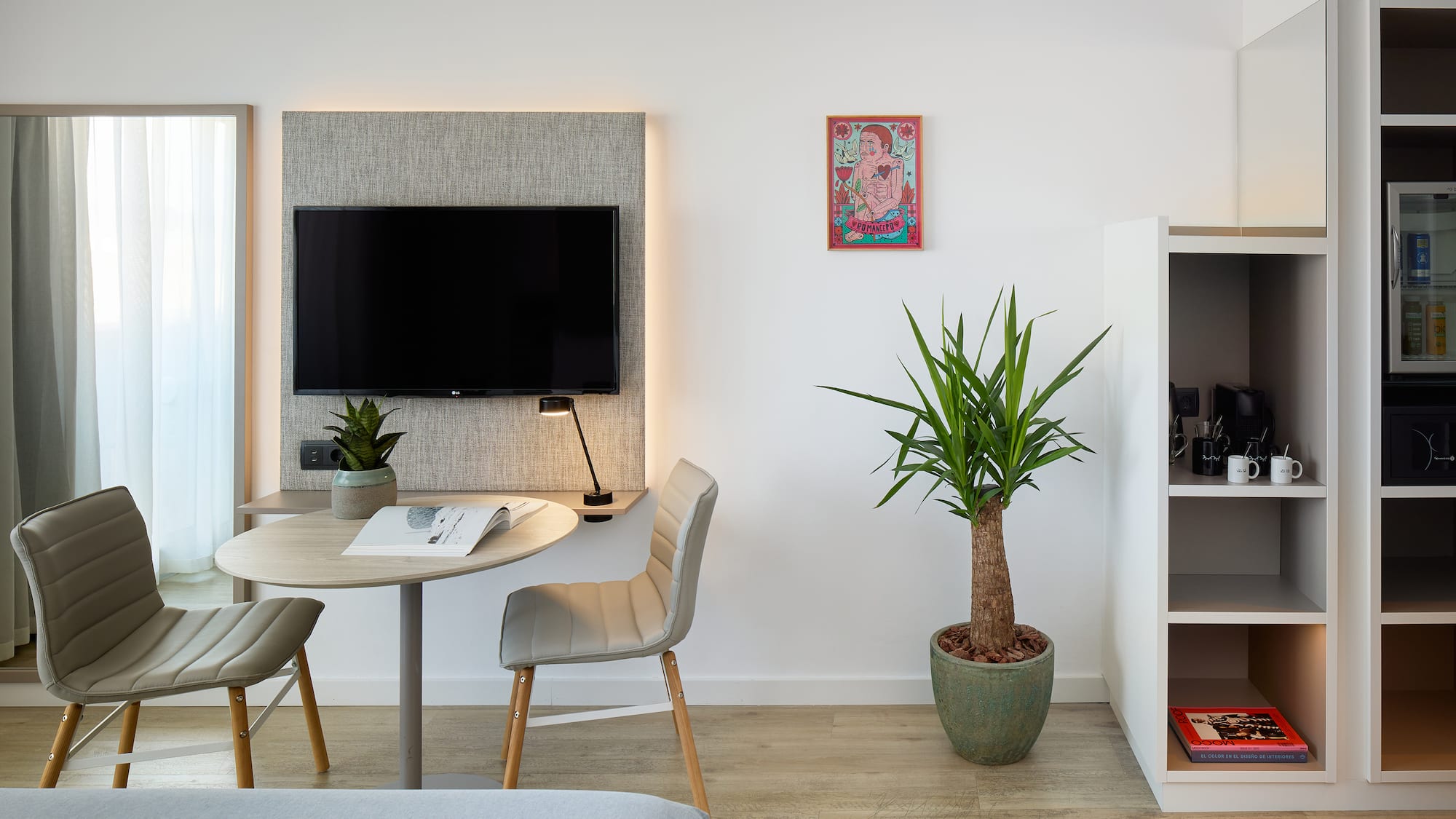 a room with a table and chairs and a tv