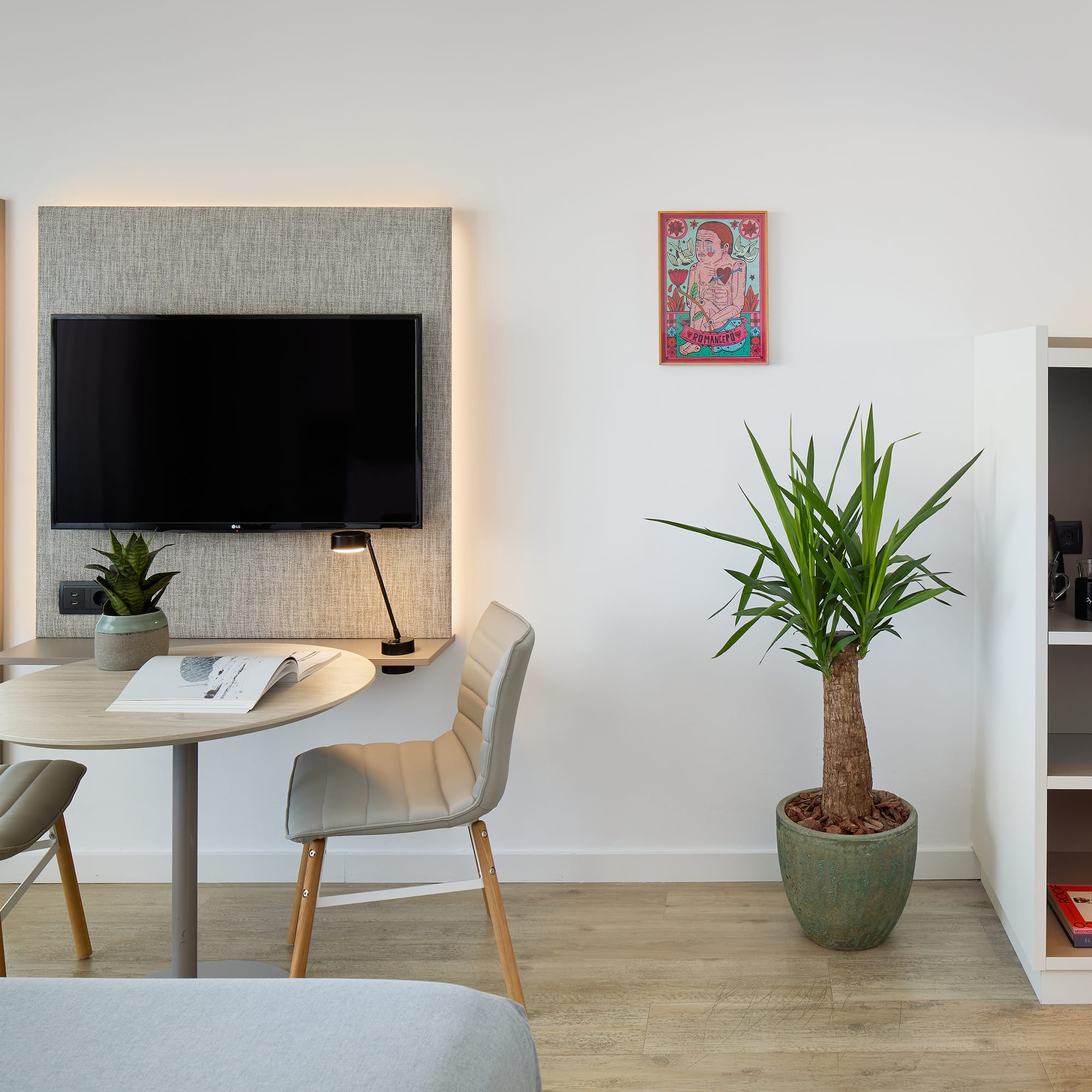 a room with a table and chairs and a tv