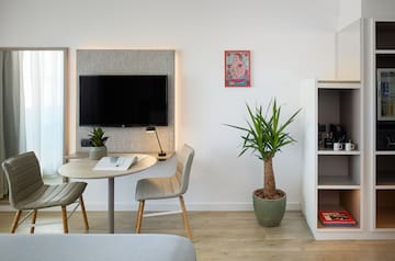 a room with a table and chairs and a tv