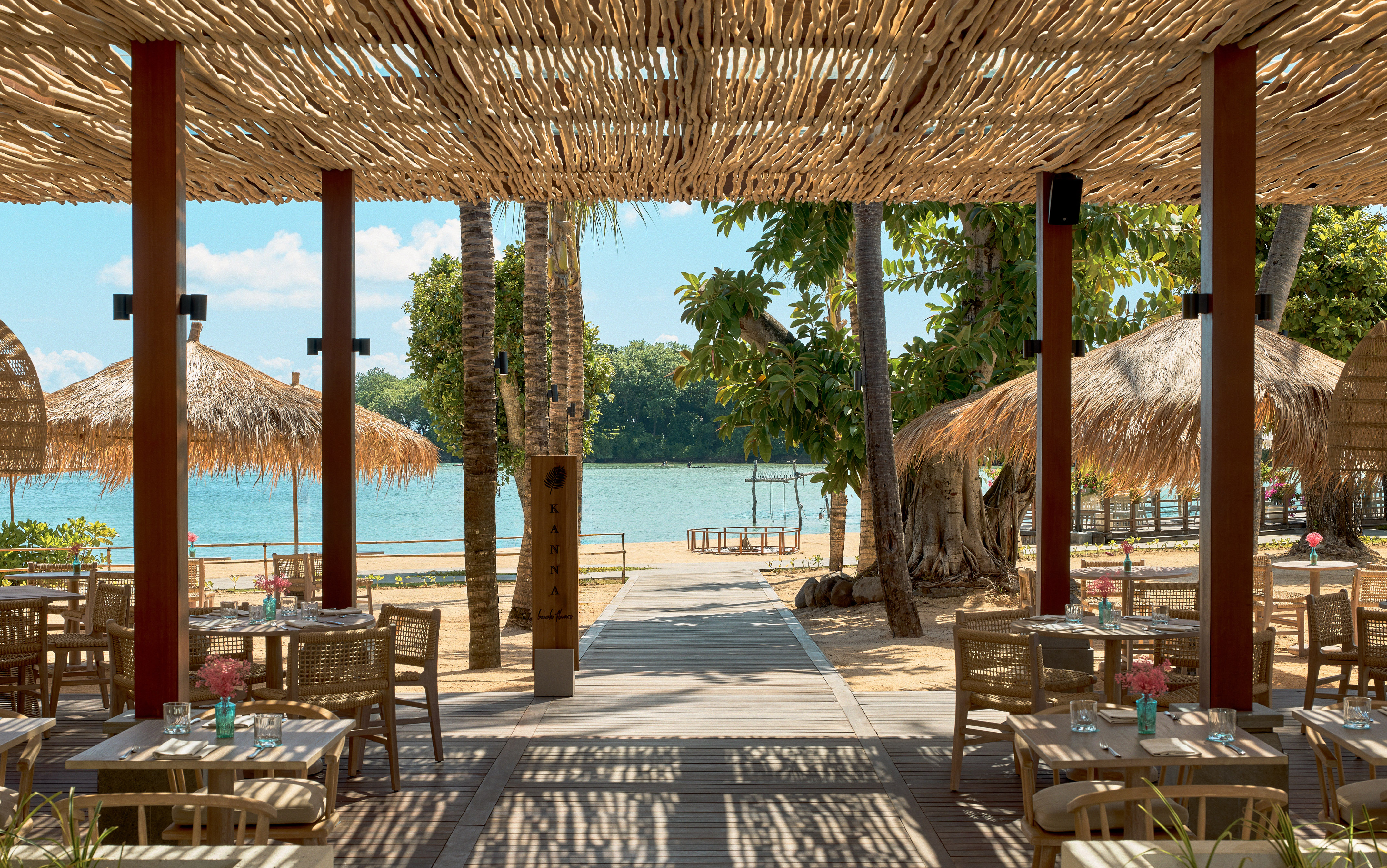 a beach restaurant with tables and chairs