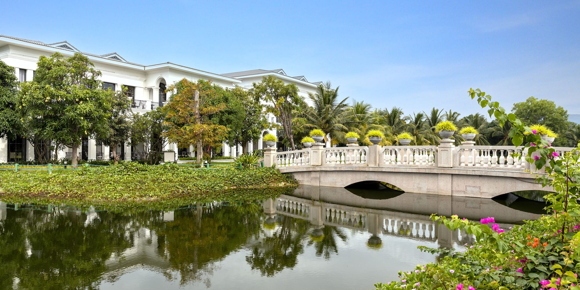 a bridge over a body of water with a building in the background