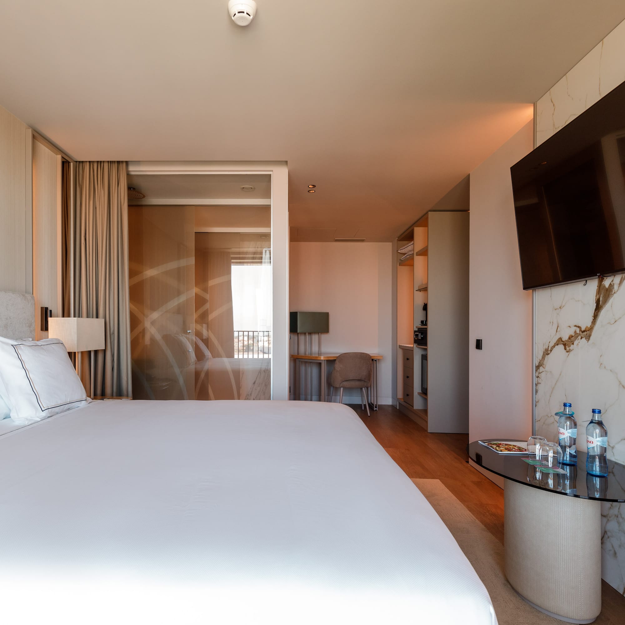 a hotel room with a bed and a table