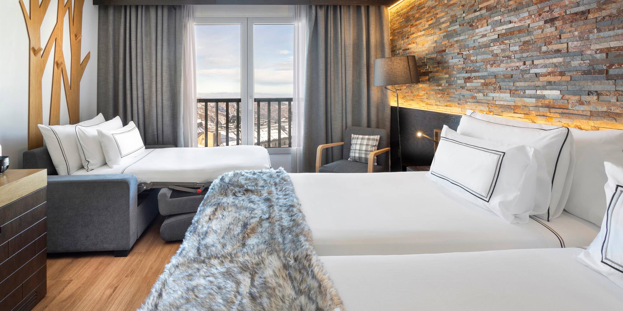 a room with two beds and a window