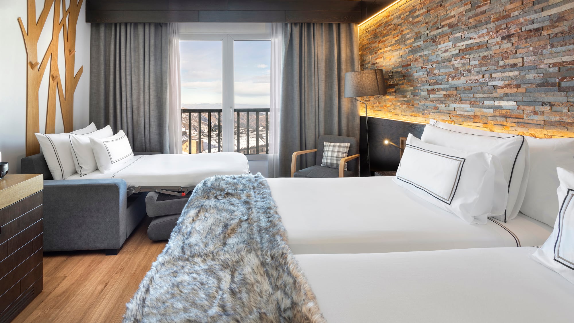 a room with two beds and a window