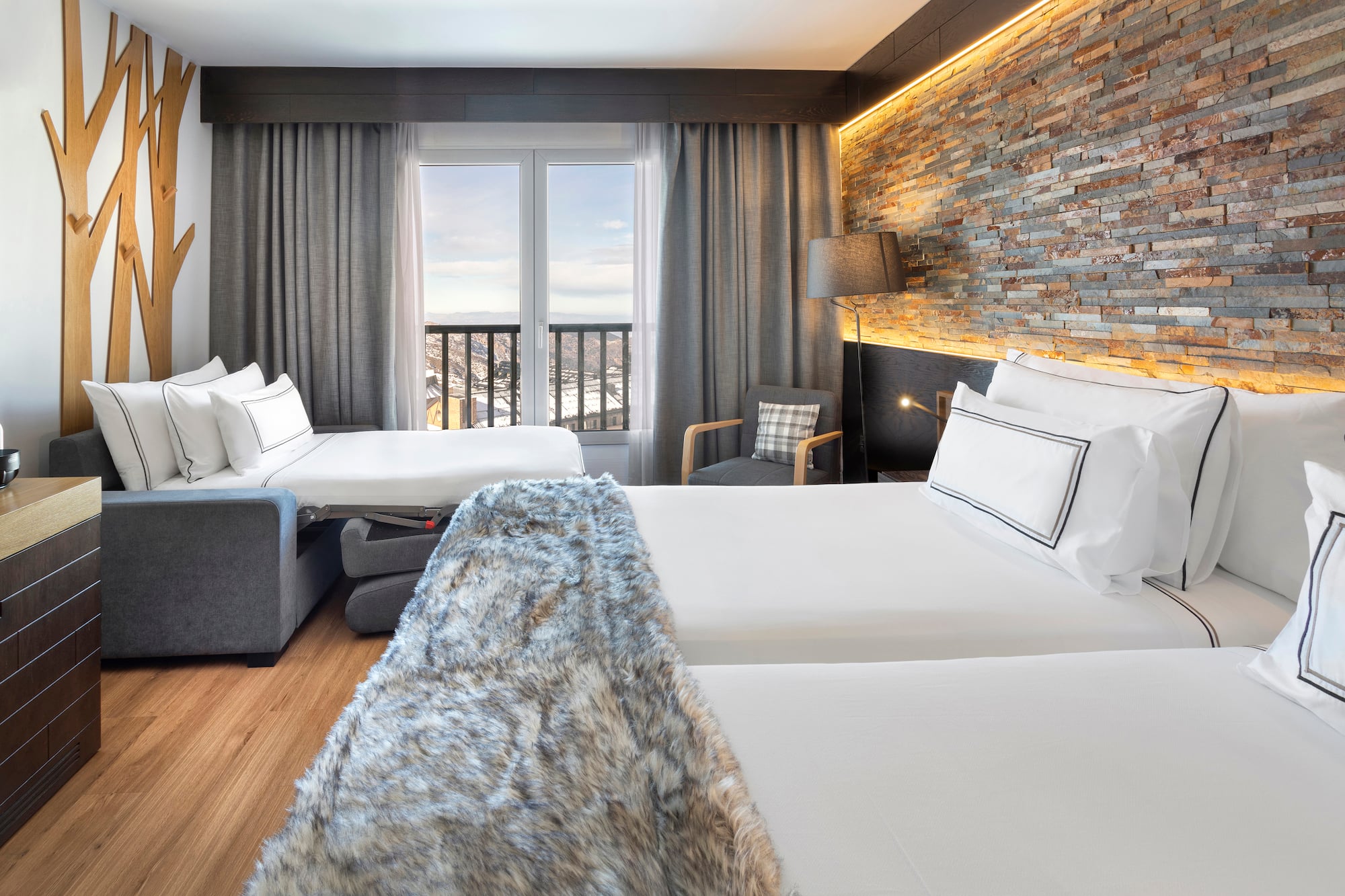 a room with two beds and a window