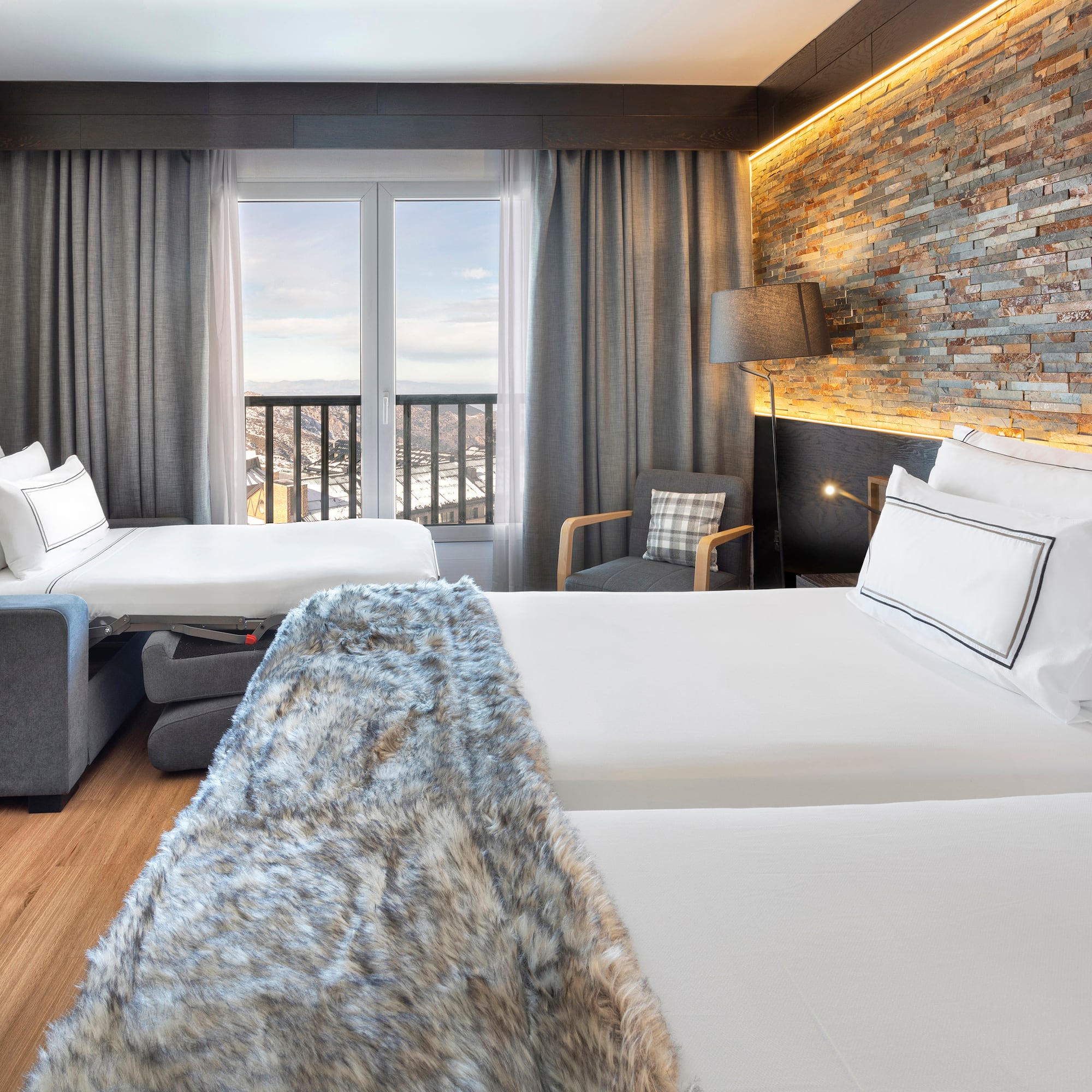 a room with two beds and a window