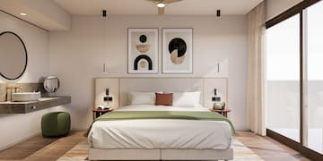 a bedroom with a bed and artwork
