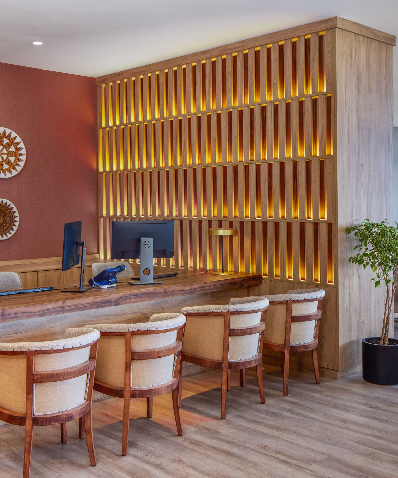 a room with a desk and chairs