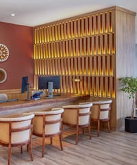 a room with a desk and chairs