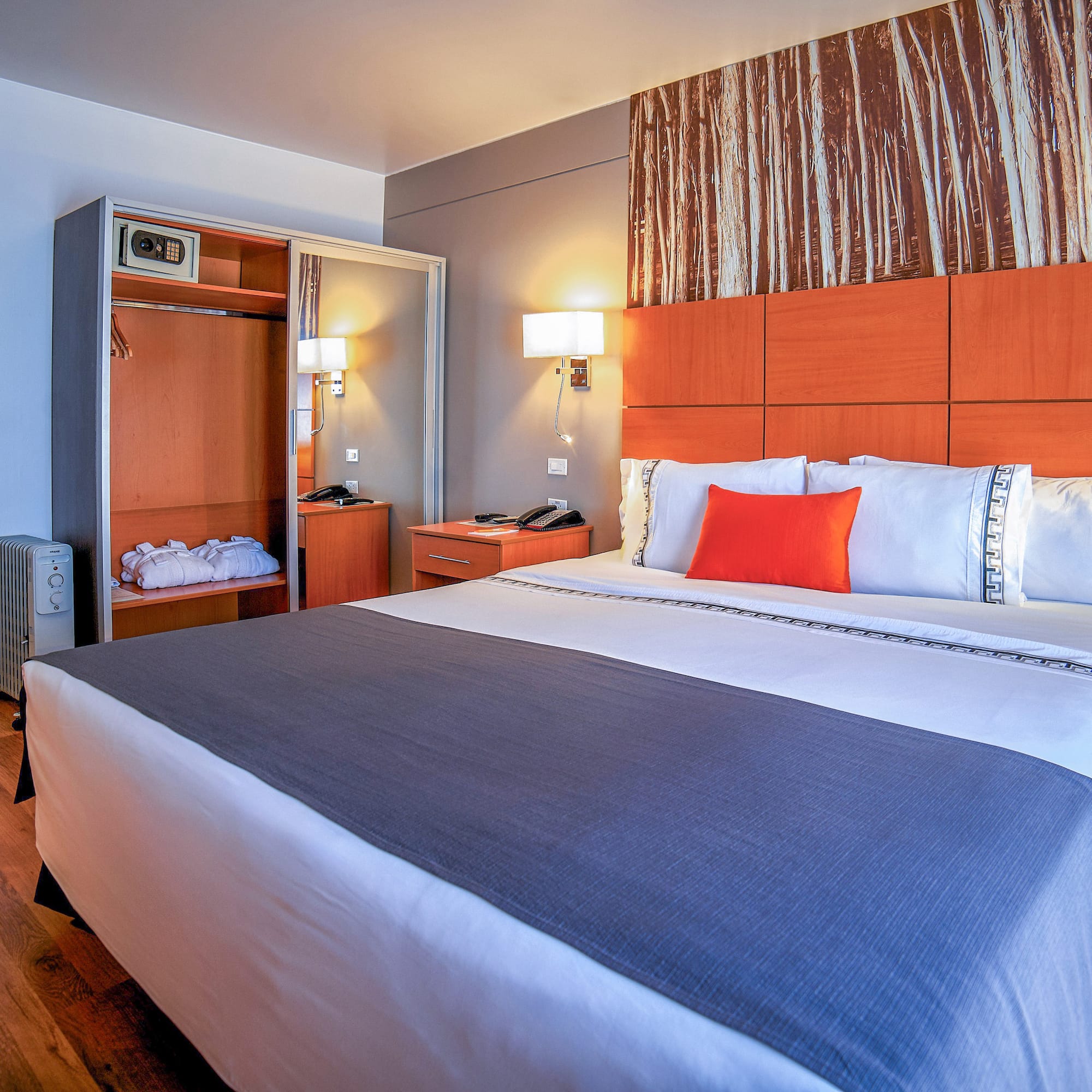 a bed with a wood headboard and a lamp