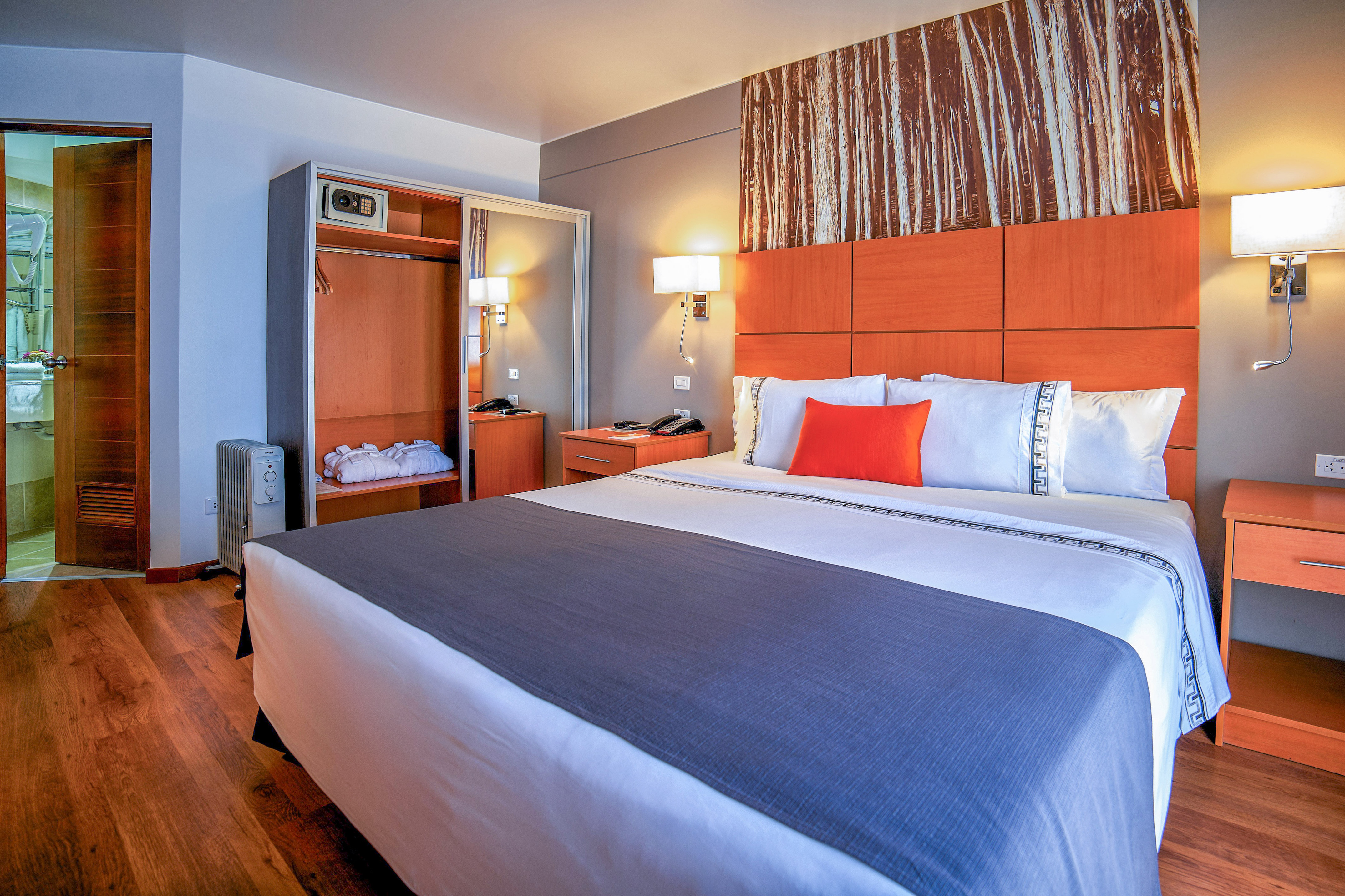 a bed with a wood headboard and a lamp
