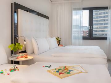 a room with two beds and a board game