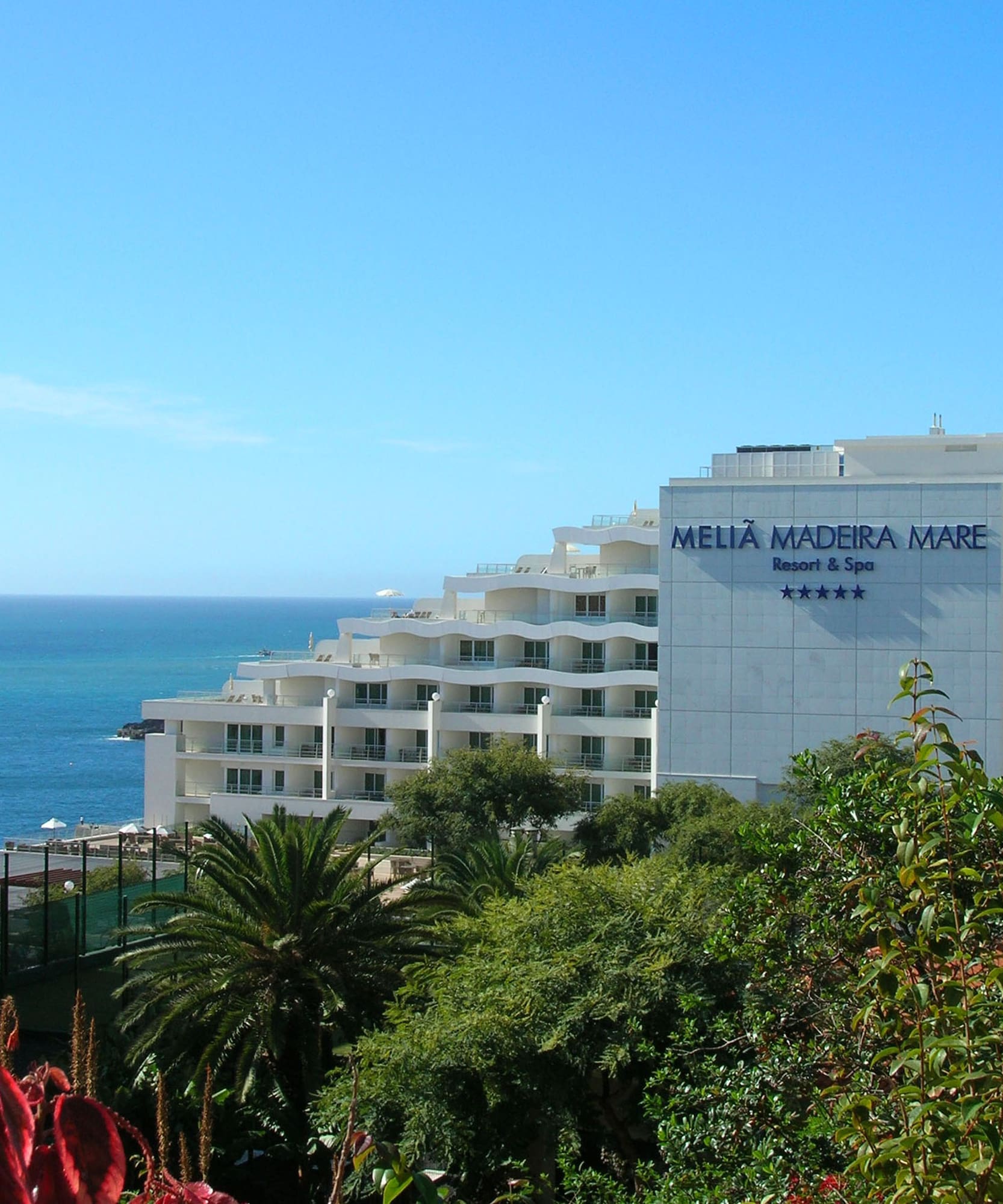 a white building next to the ocean