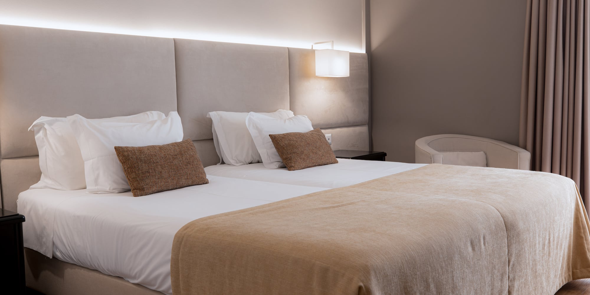 a bed with a light on the wall