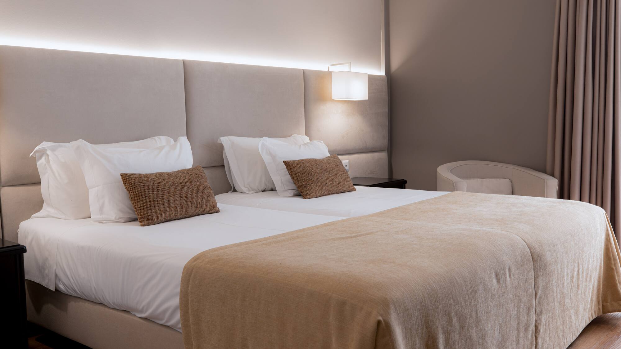 a bed with a light on the wall