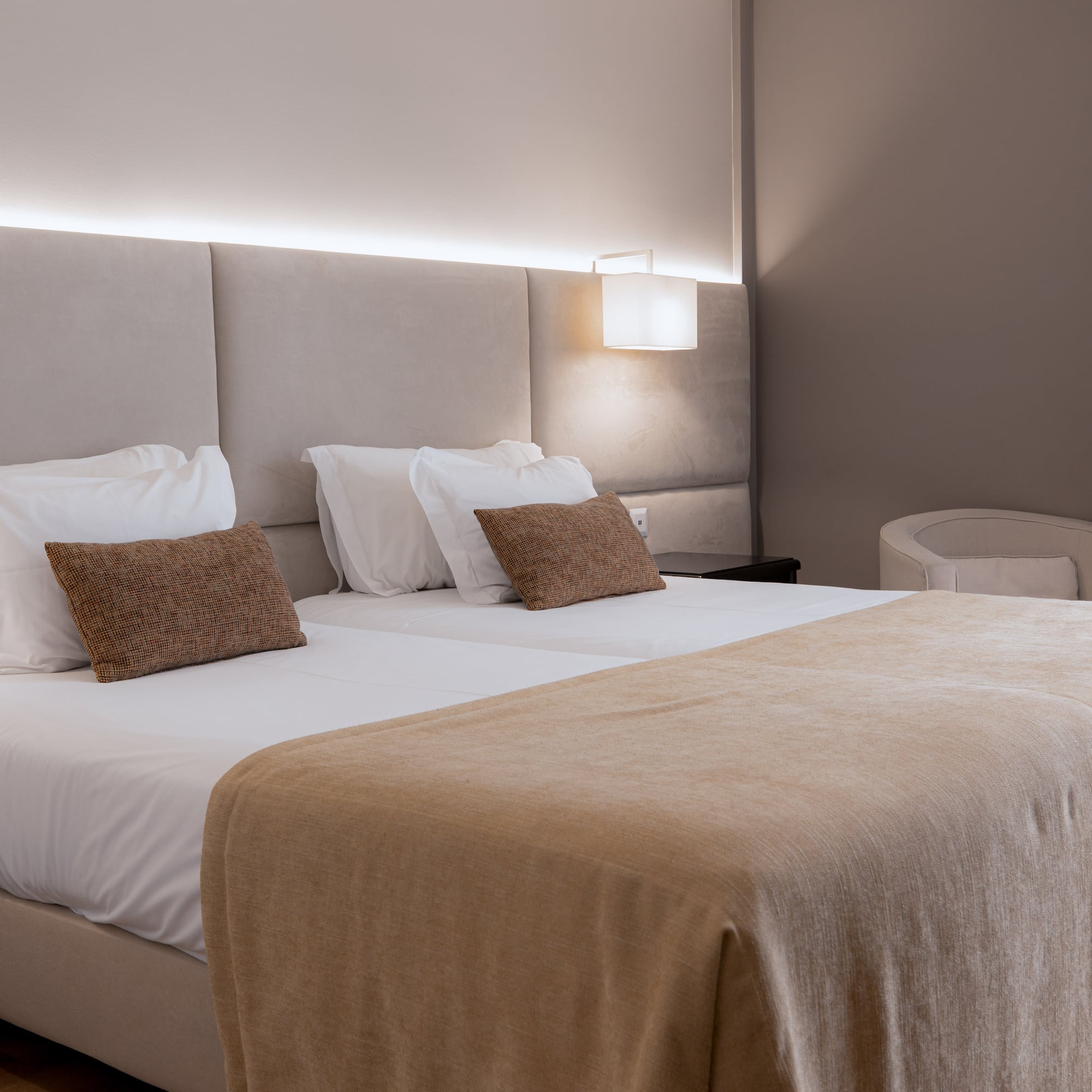 a bed with a light on the wall