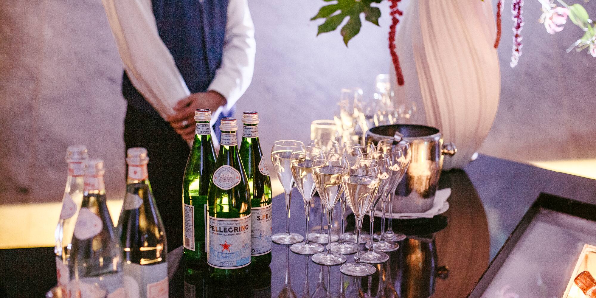 a group of wine glasses and bottles on a table