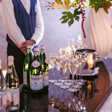 a group of wine glasses and bottles on a table