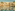 Tropical resort hotel with large pool, palm trees, balconies.
