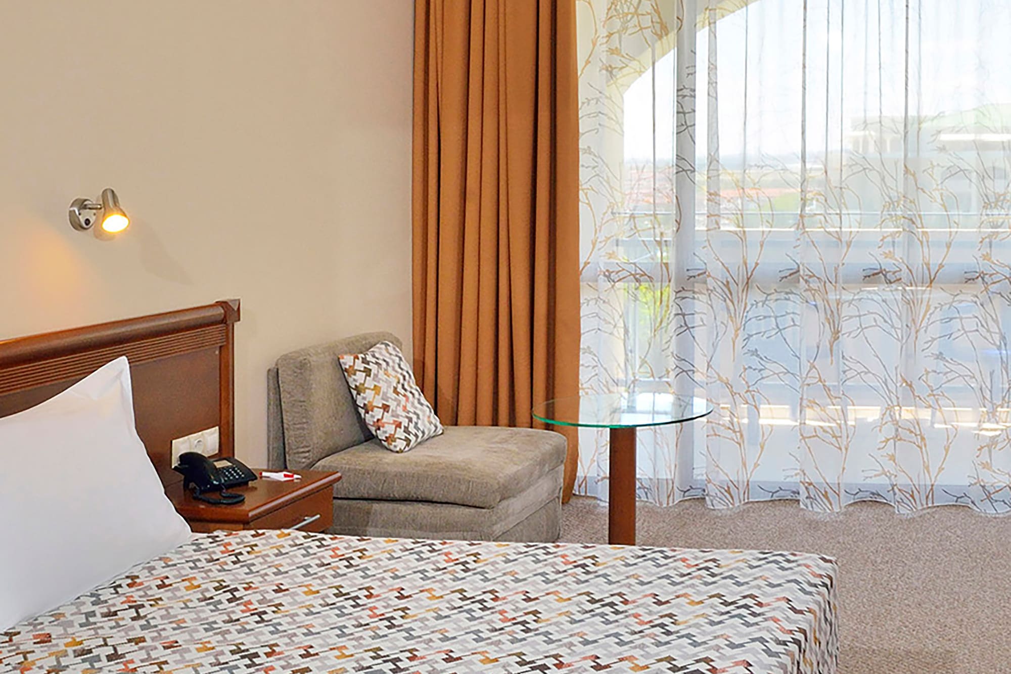 a bedroom with a bed and a chair