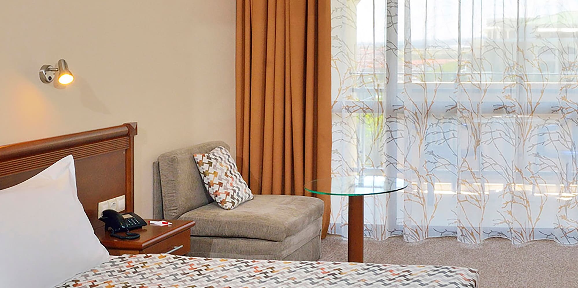 a bedroom with a bed and a chair