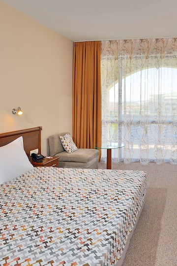 a bedroom with a bed and a chair