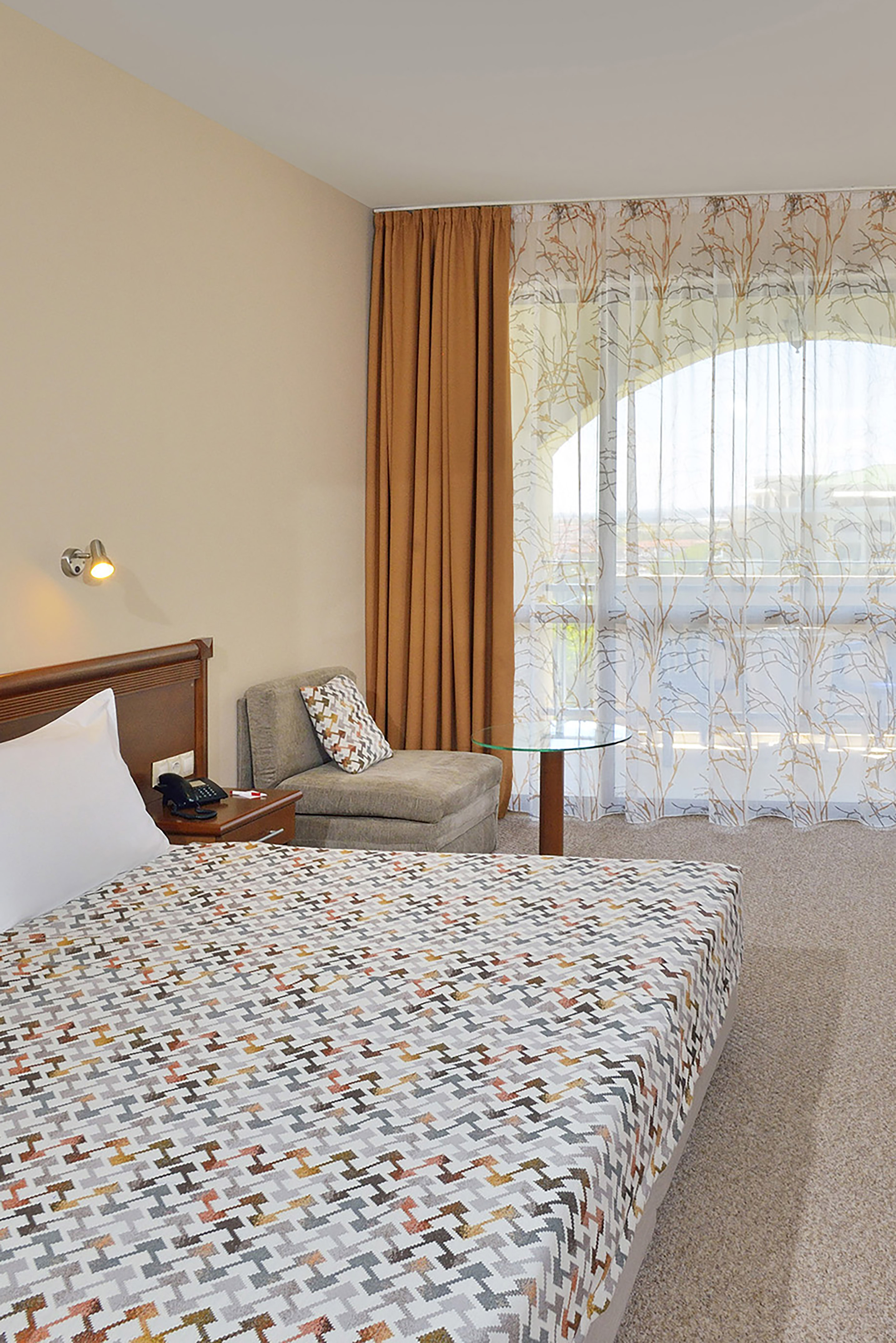 a bedroom with a bed and a chair