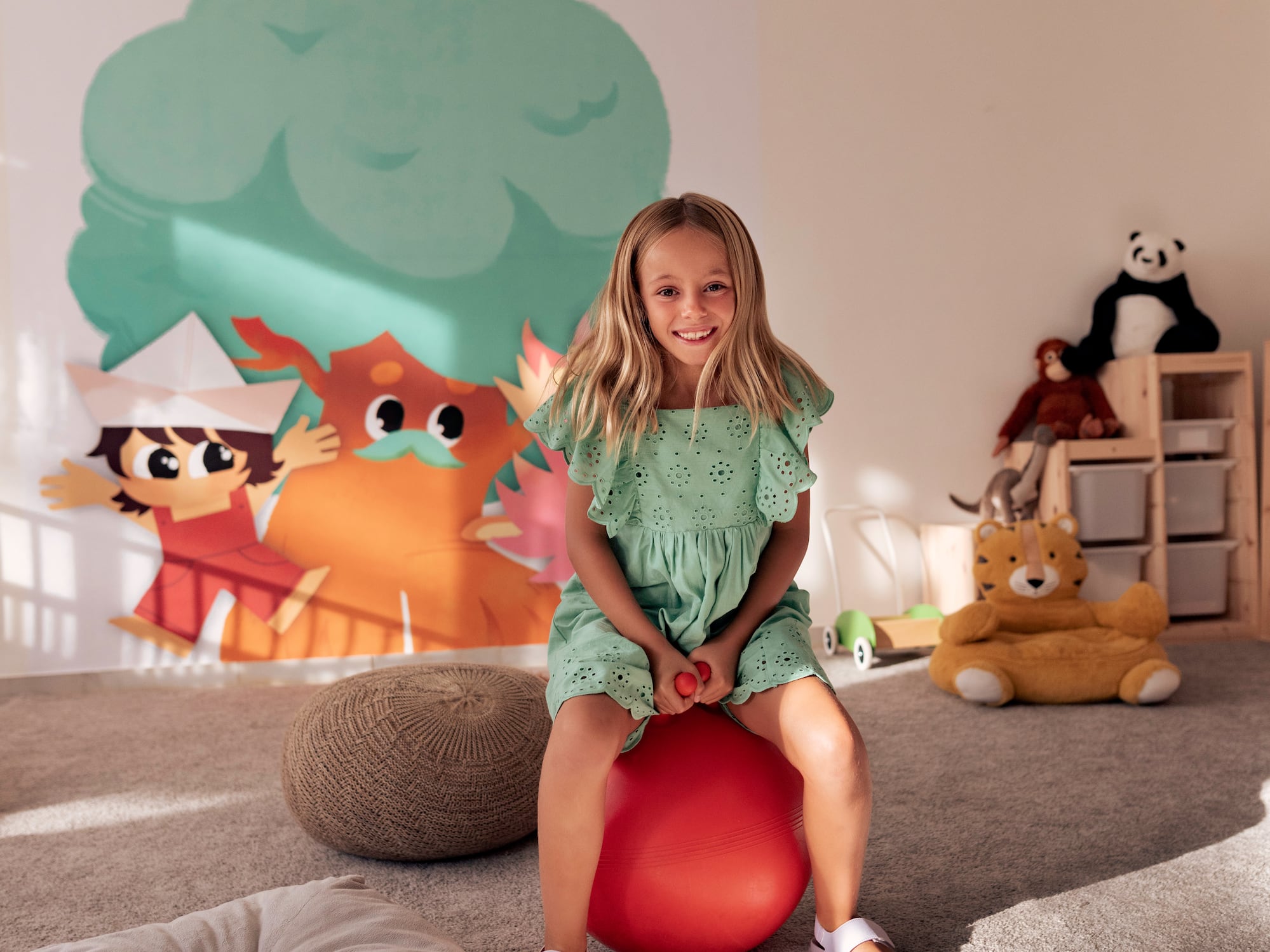 a girl sitting on a ball