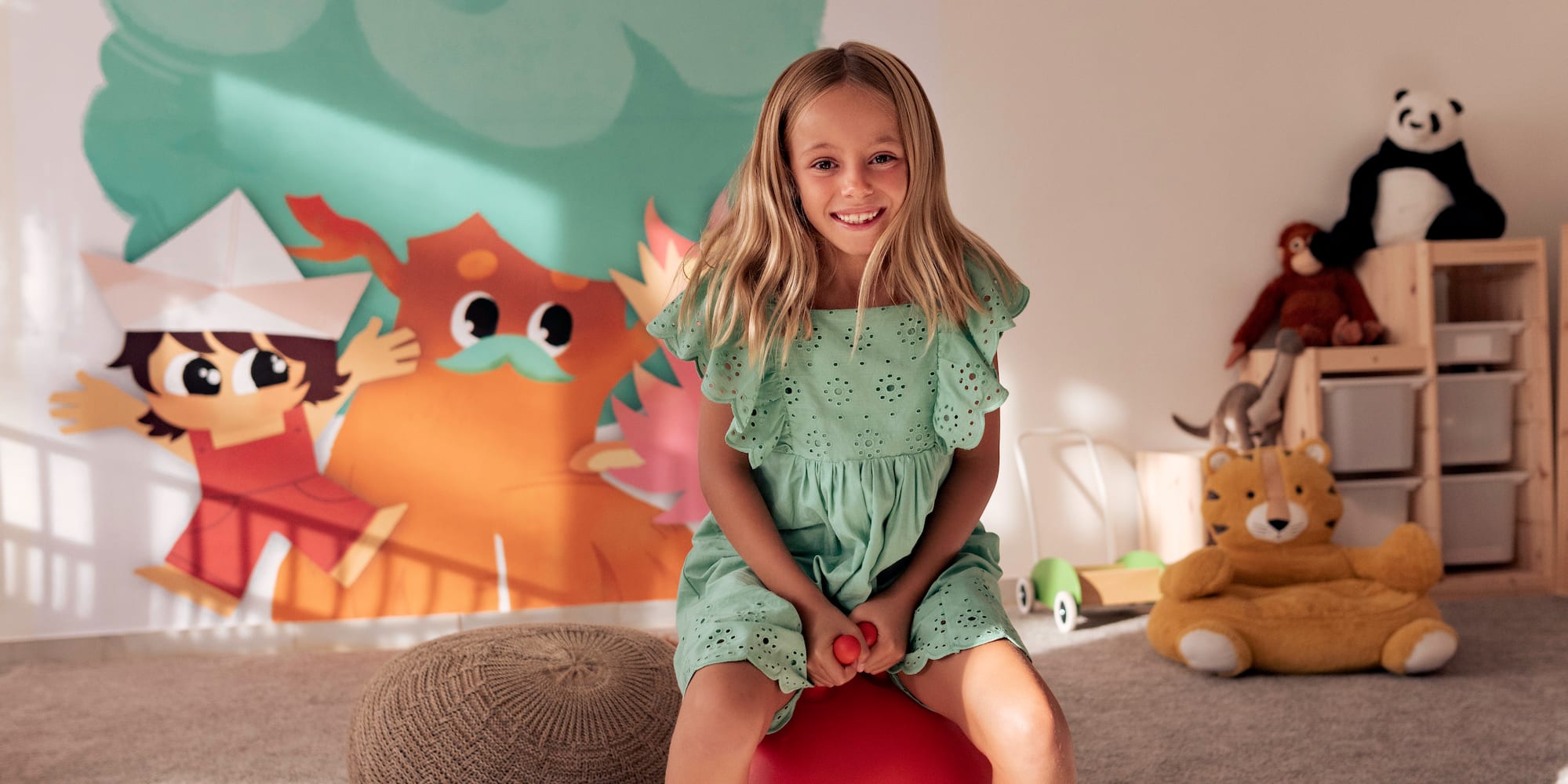 a girl sitting on a ball