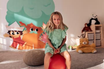 a girl sitting on a ball