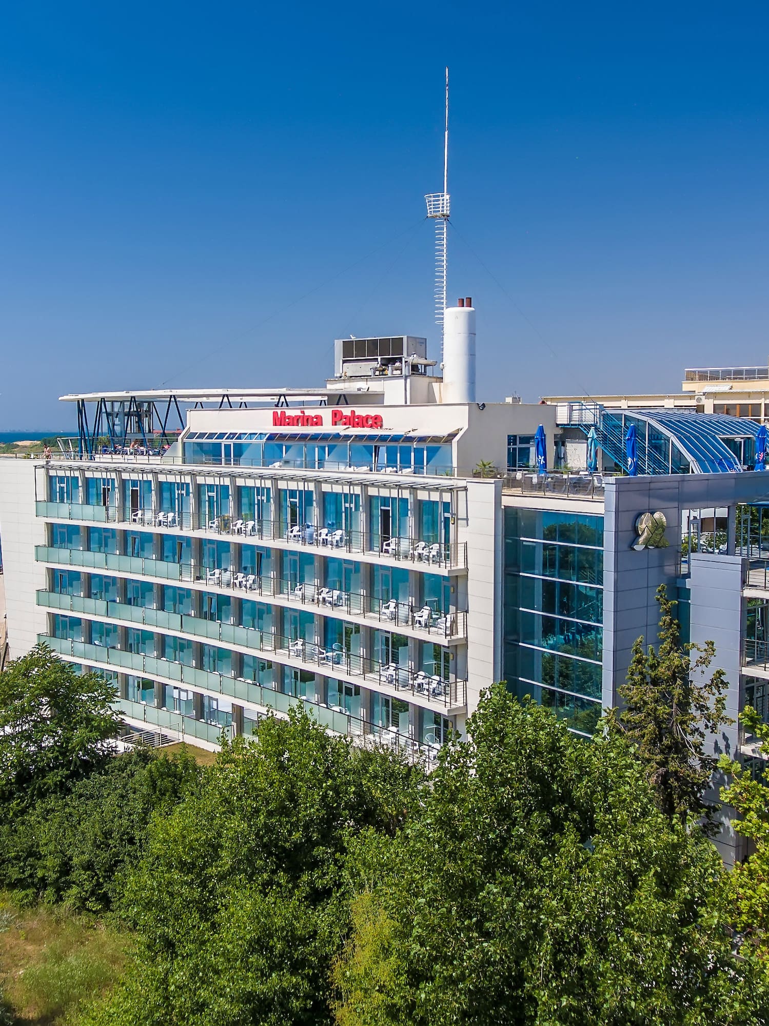 a building with a body of water in the background