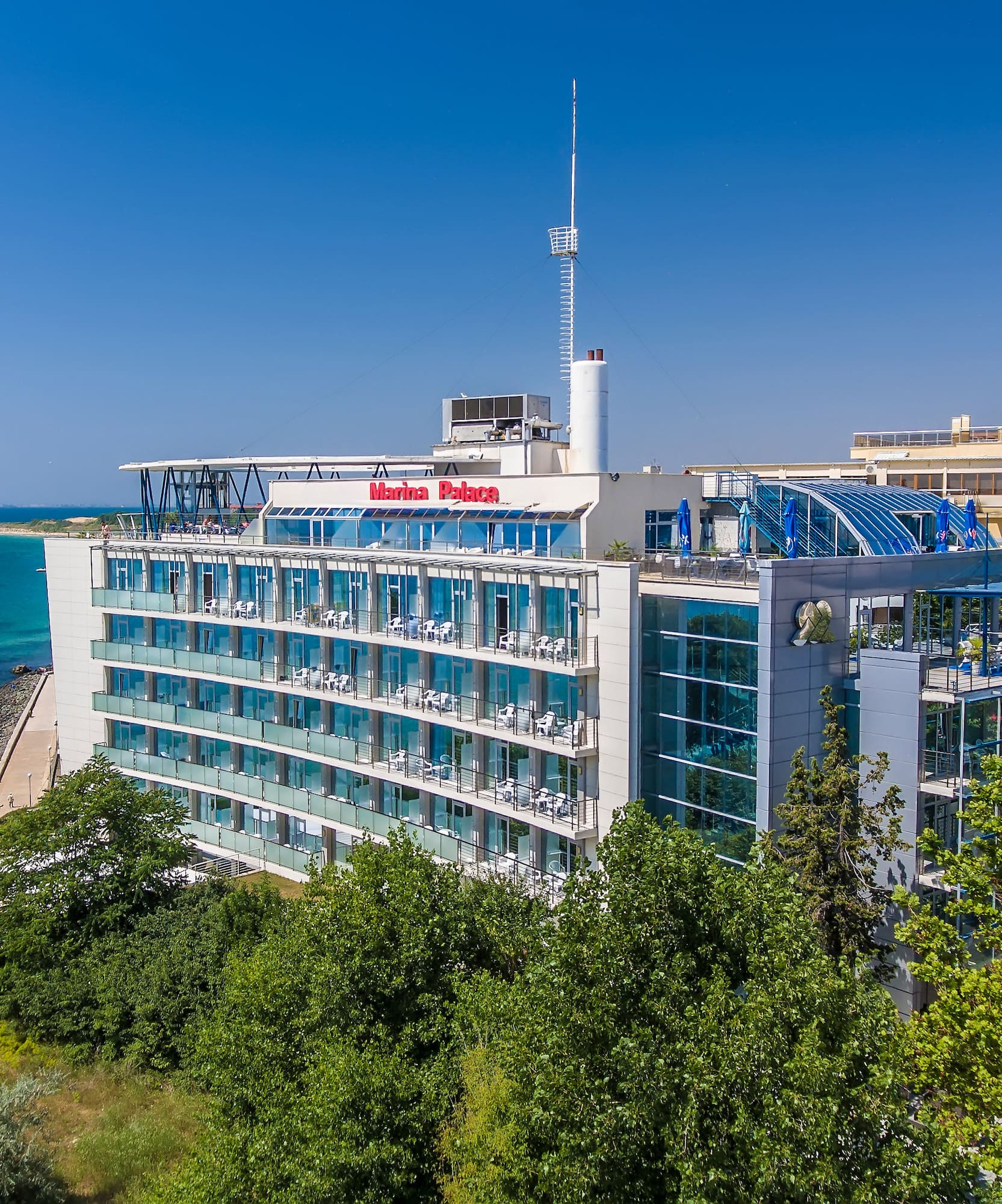 a building with a body of water in the background