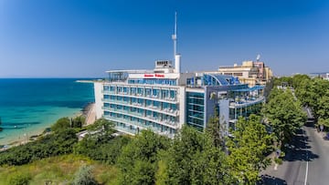 a building with a body of water in the background