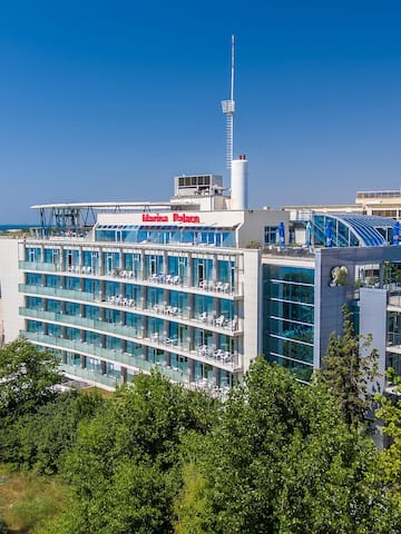 a building with a body of water in the background