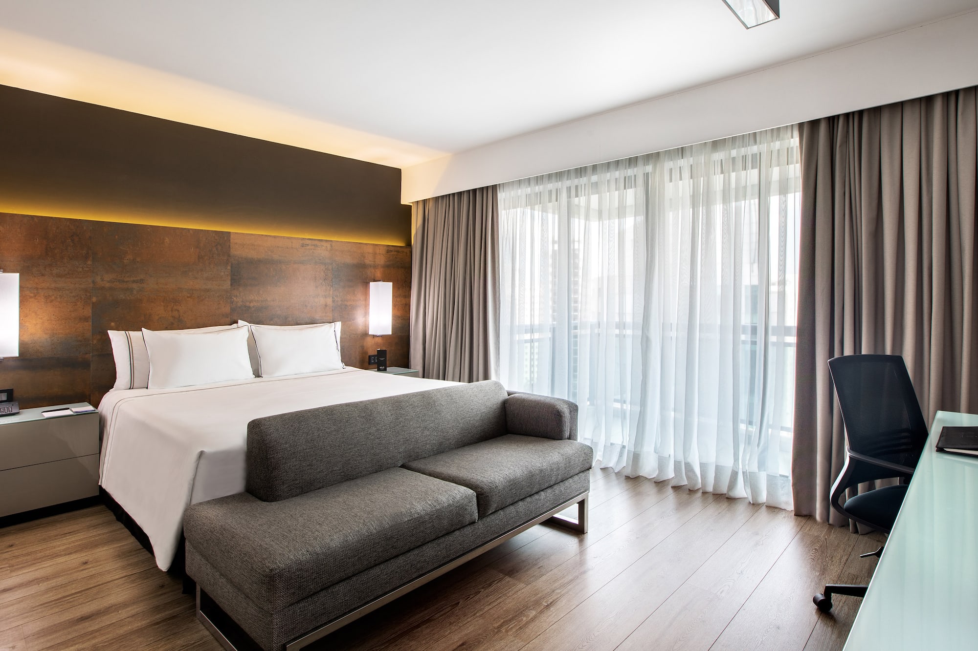 a bed and couch in a hotel room