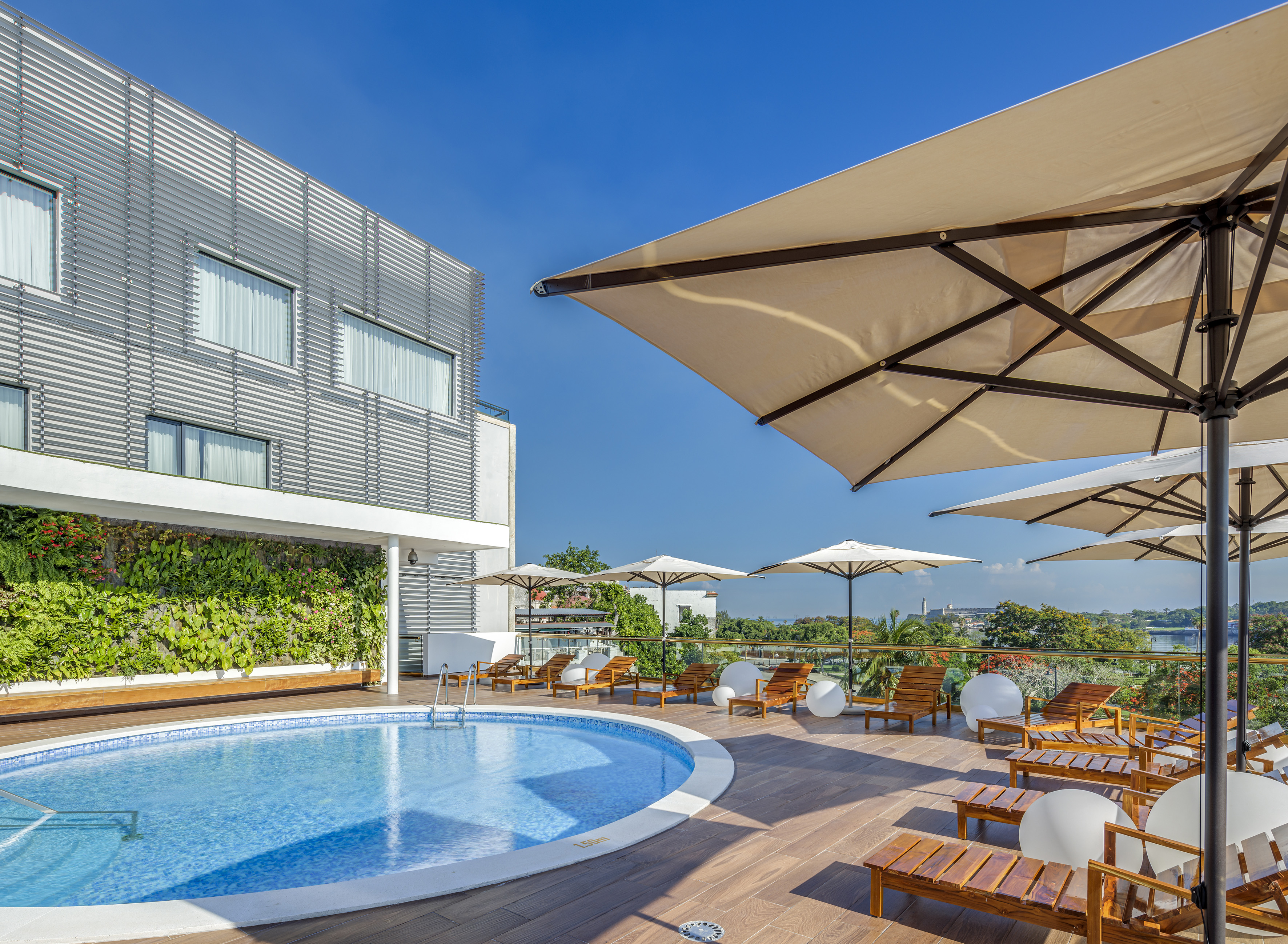 a pool with chairs and umbrellas on a deck