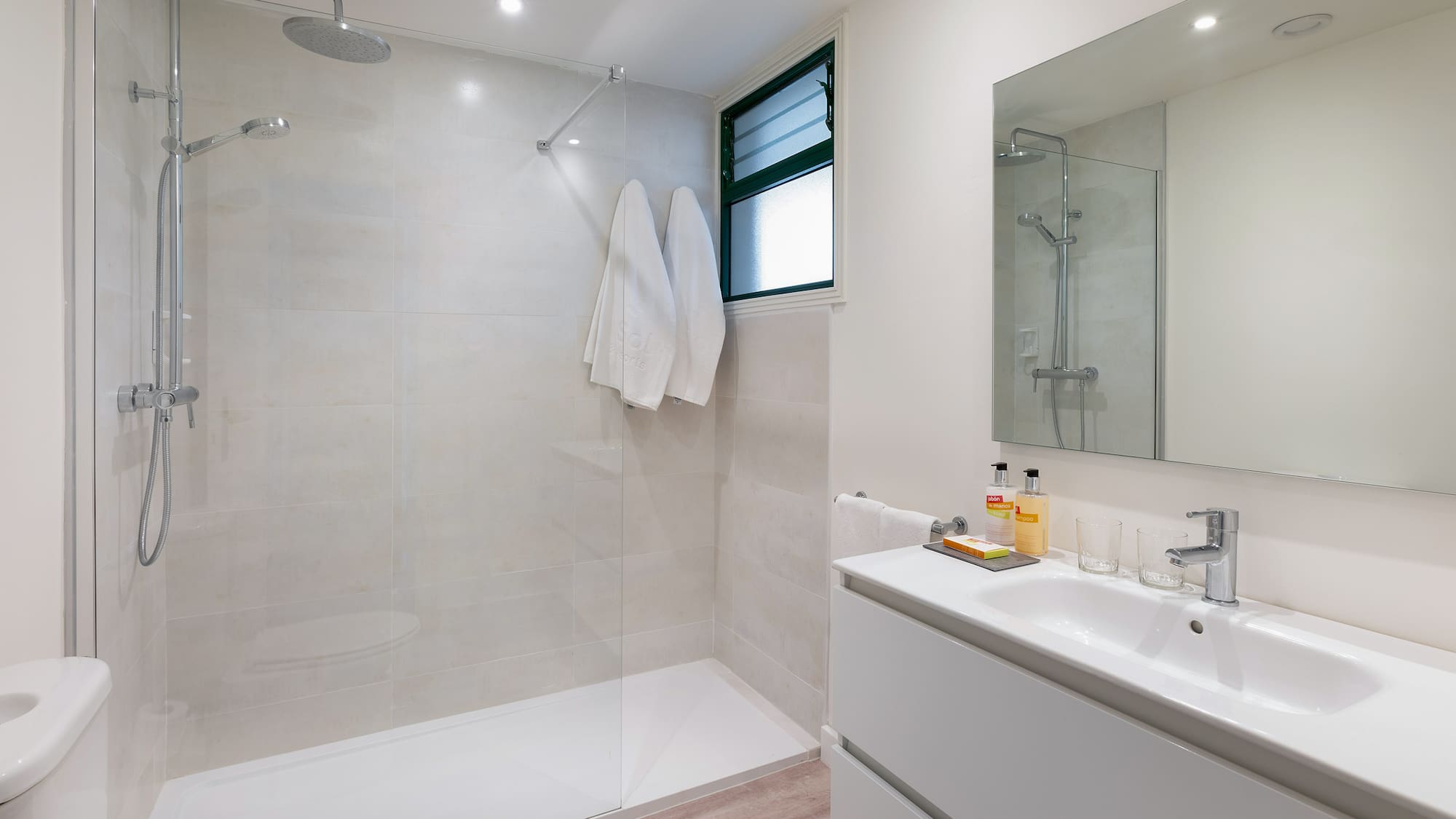 a bathroom with a shower and sink