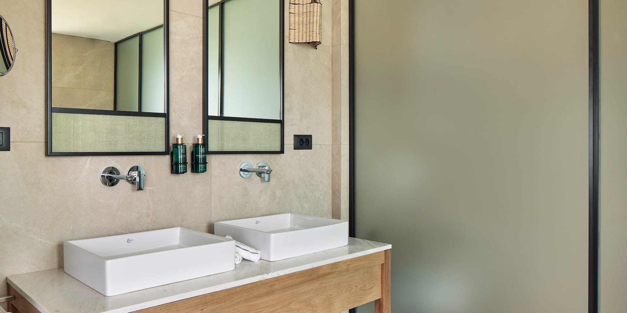 a bathroom with two sinks and a shower