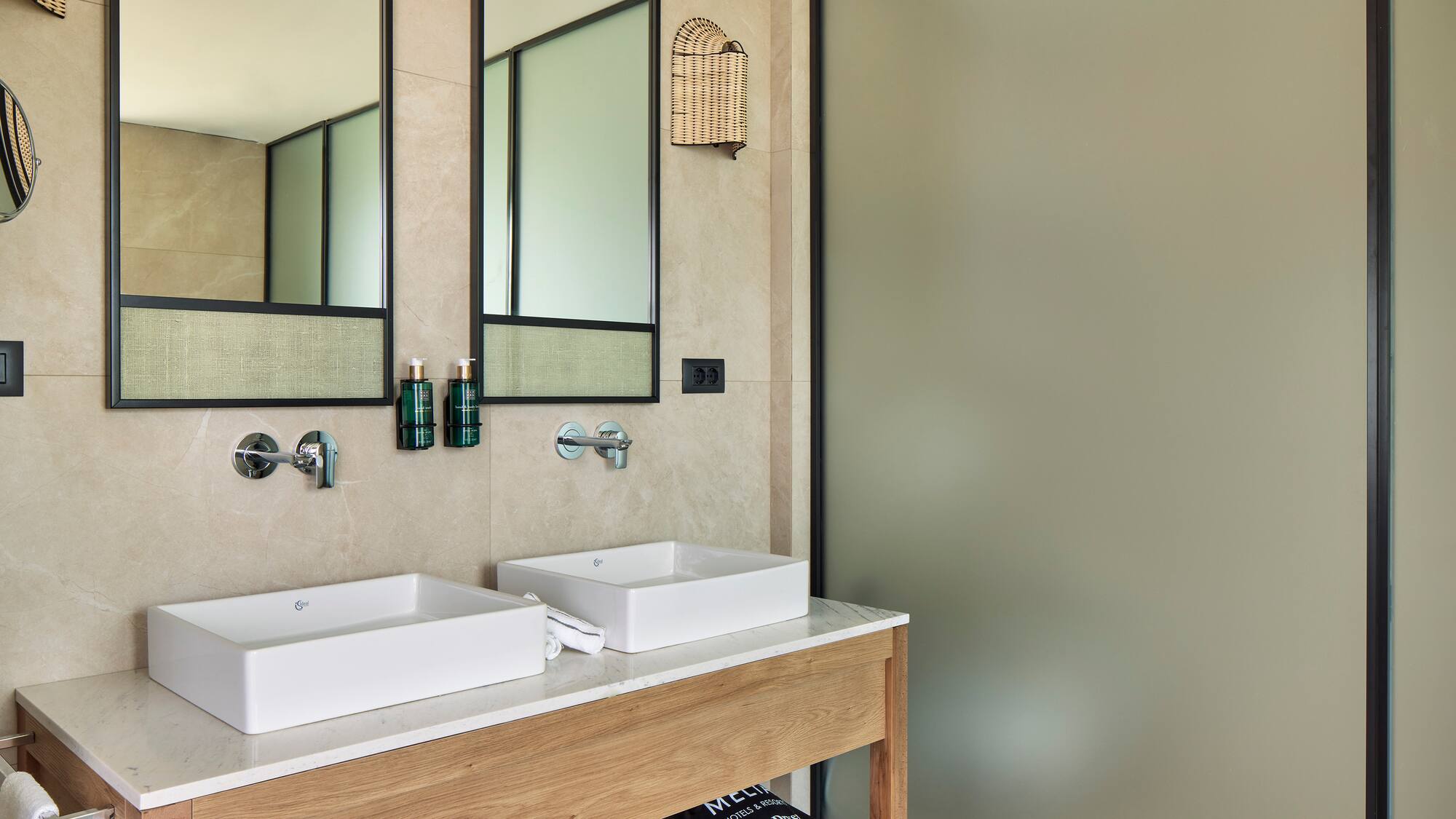 a bathroom with two sinks and a shower