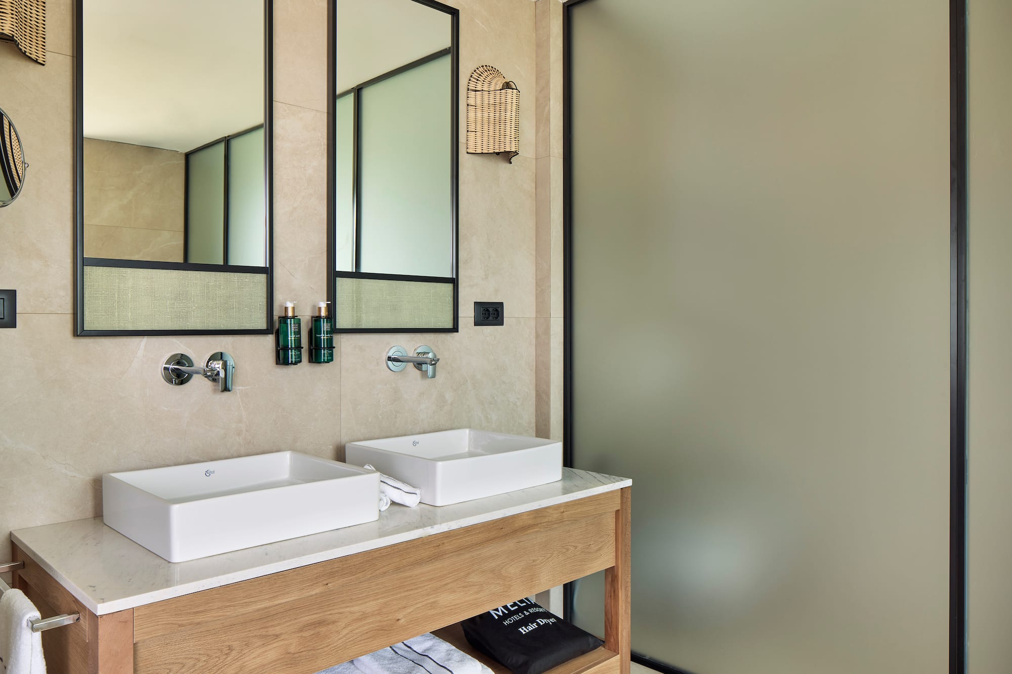 a bathroom with two sinks and a shower