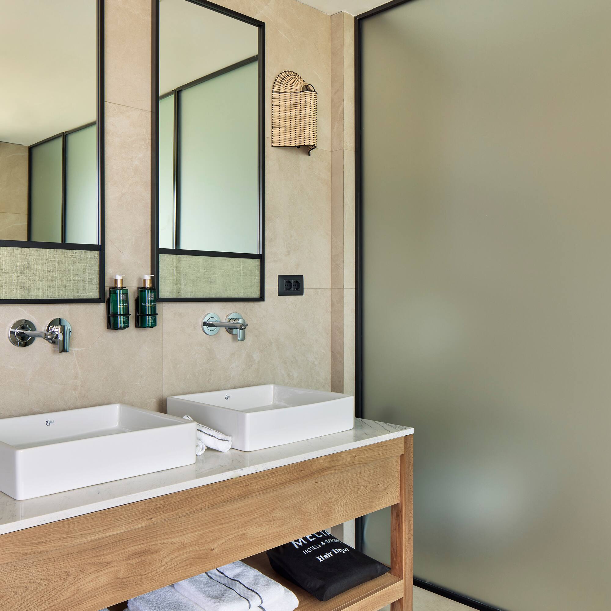 a bathroom with two sinks and a shower