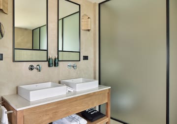 a bathroom with two sinks and a shower