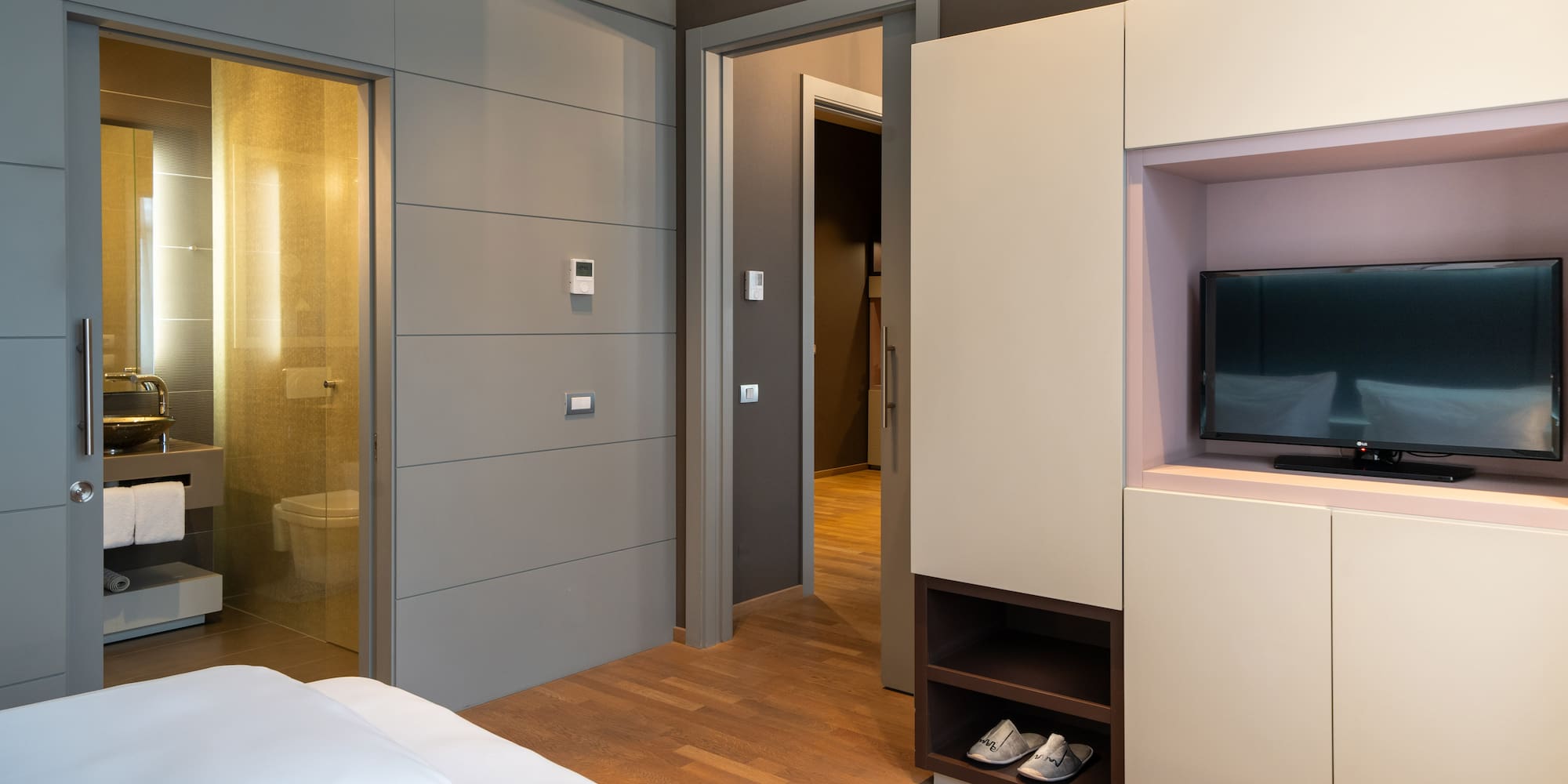 a room with a bed and a tv