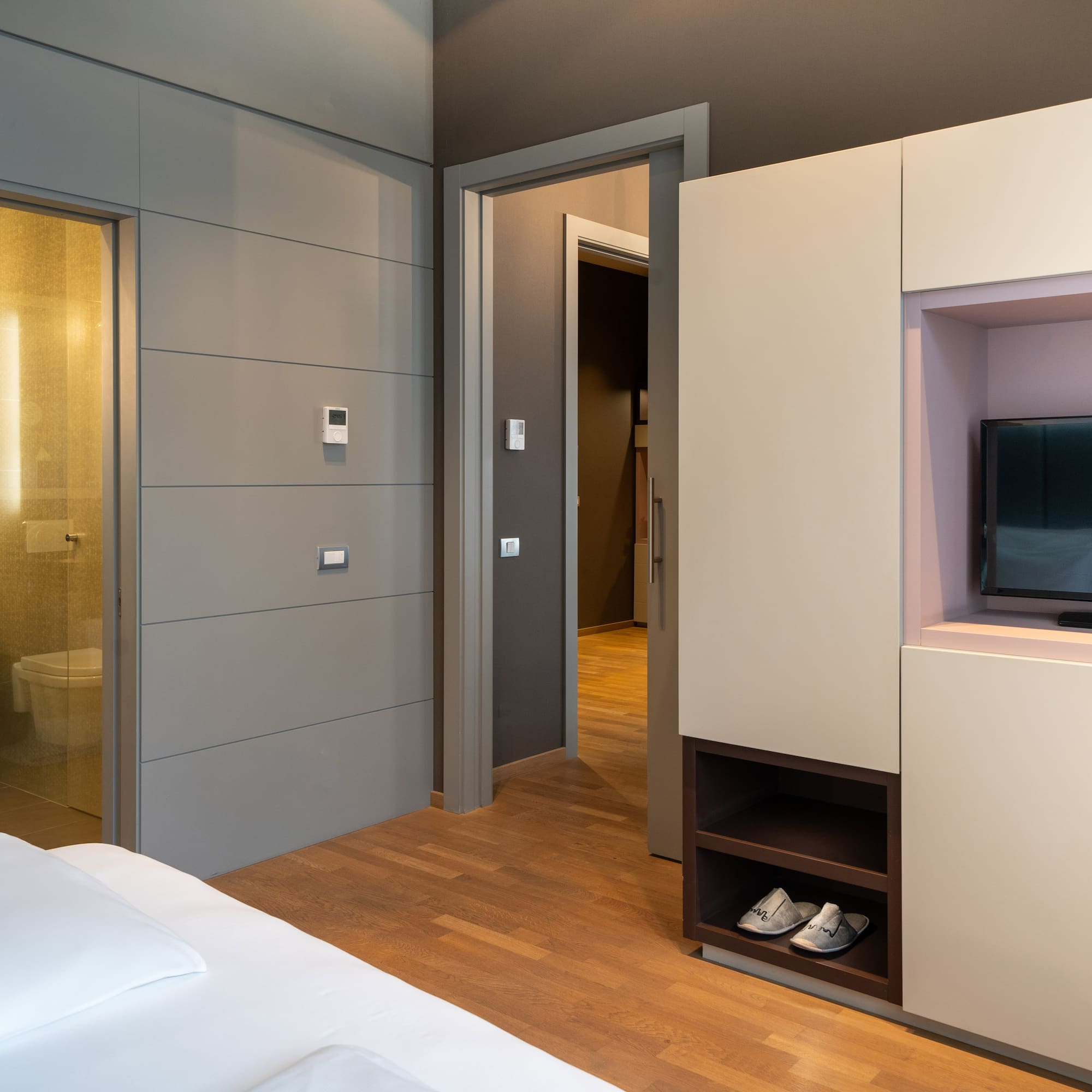 a room with a bed and a tv