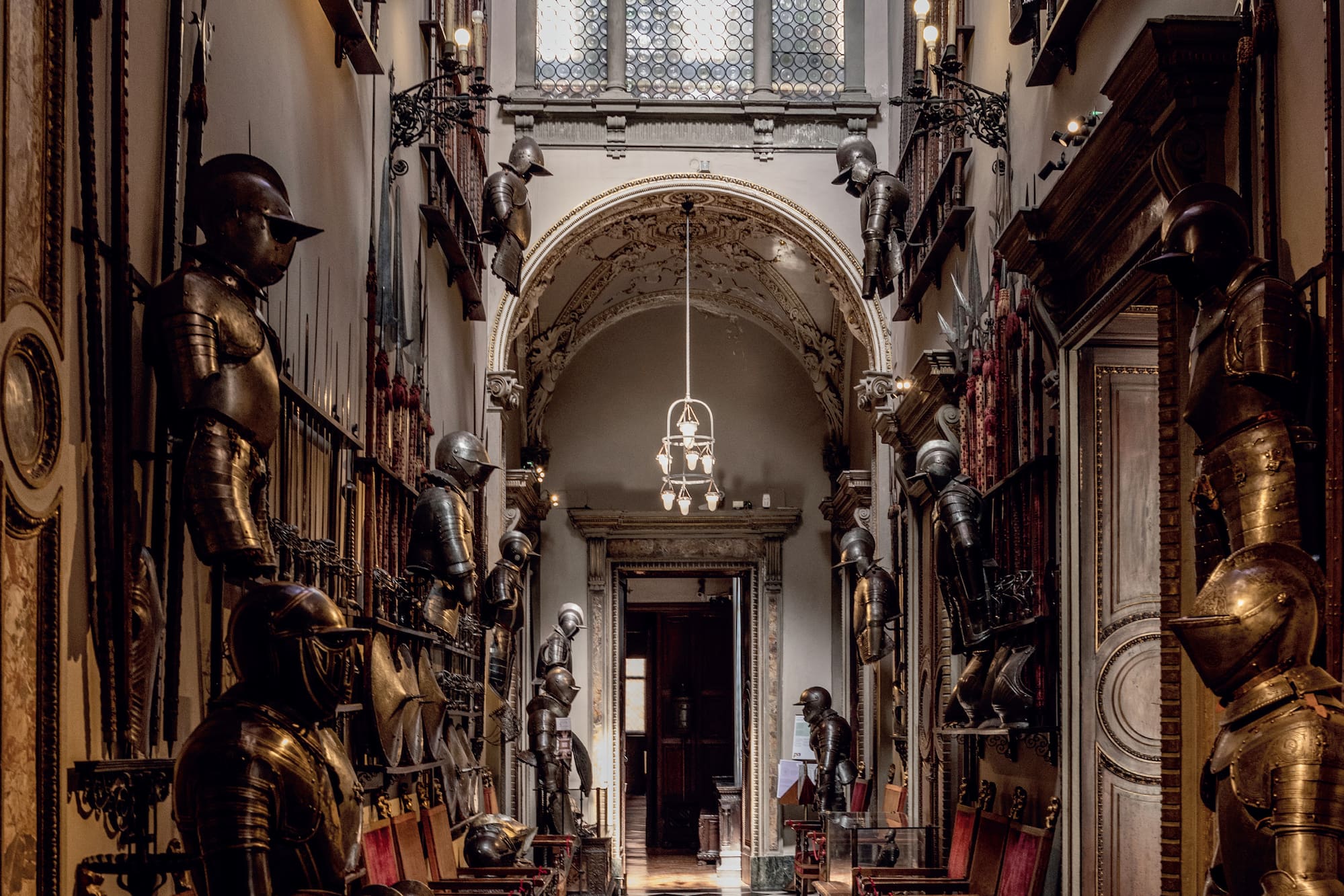 a hallway with armor and armor on the walls