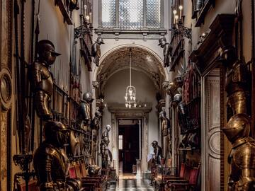 a hallway with armor and armor on the walls